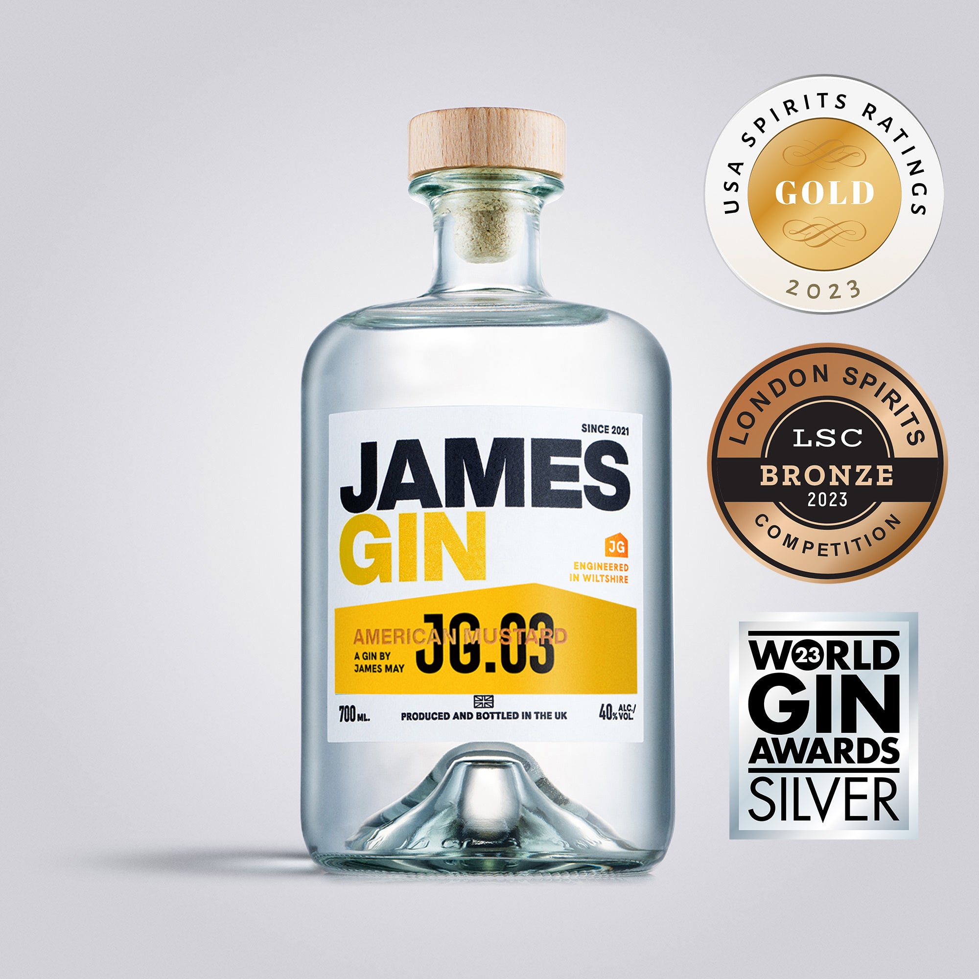 Bottle of James Gin with awards on a gray background
