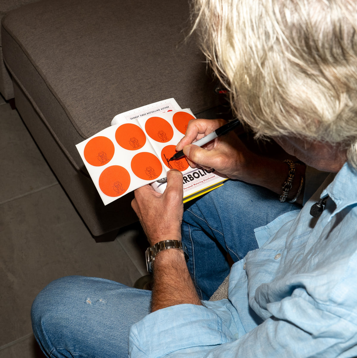 James May signing copies of his Carbolics book for the James May Carbolics signed book and gin gift bundle from James Gin.