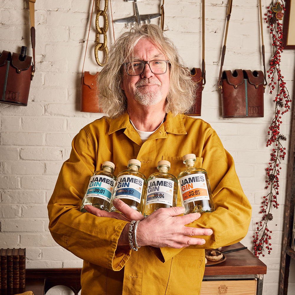 James May holding The Fab Four Gin Bundle. Featuring Asian Parsnip, California Dreamgin, London Drizzle and Asian Parsnip Navy Strength. Produced and Bottled in the UK.