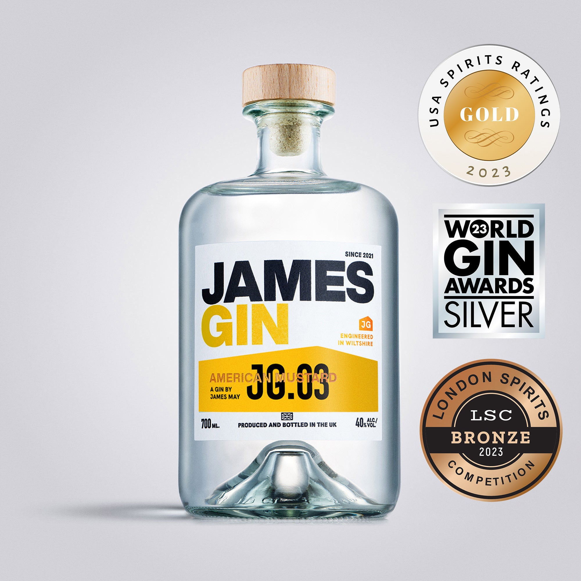 Bottle of James Gin with awards on a gray background